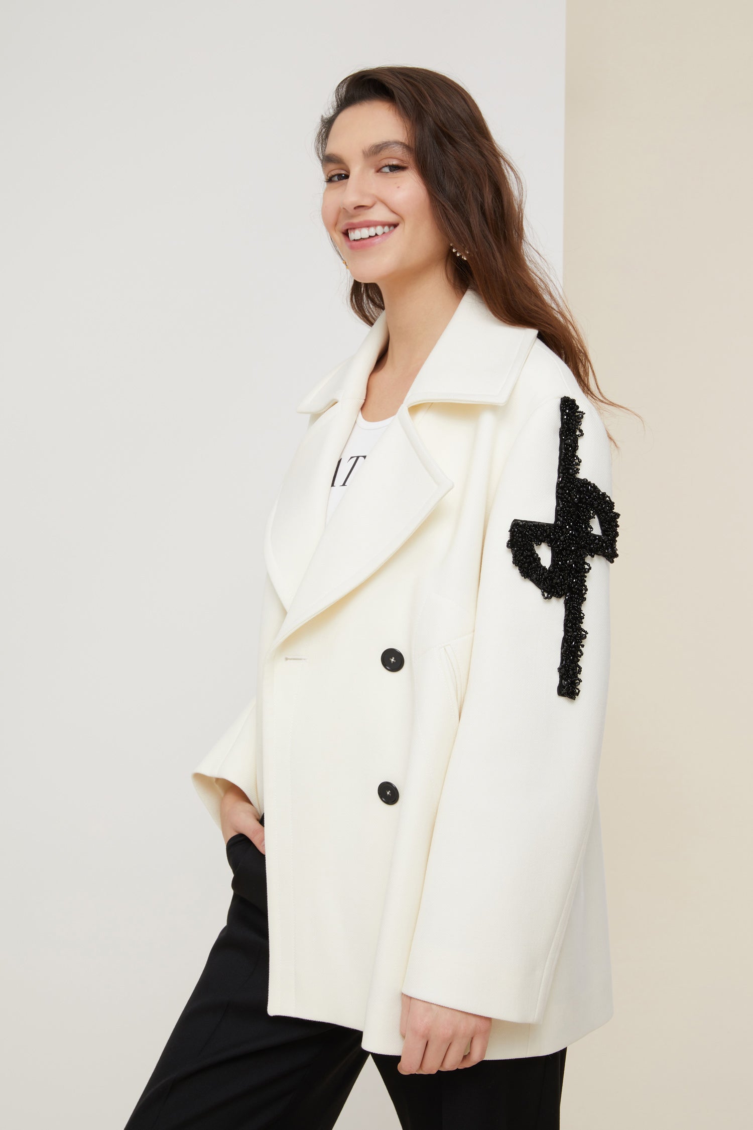 Patou - Jewelled logo peacoat - Pearl - The logo, a signature and an embellishment.Pearl white virgin wool peacoat. Double-breasted style with exaggerated lapels. JP logo in black pearls on the left sleeve. Contrasting black buttons. Welt pockets. Fully lined.