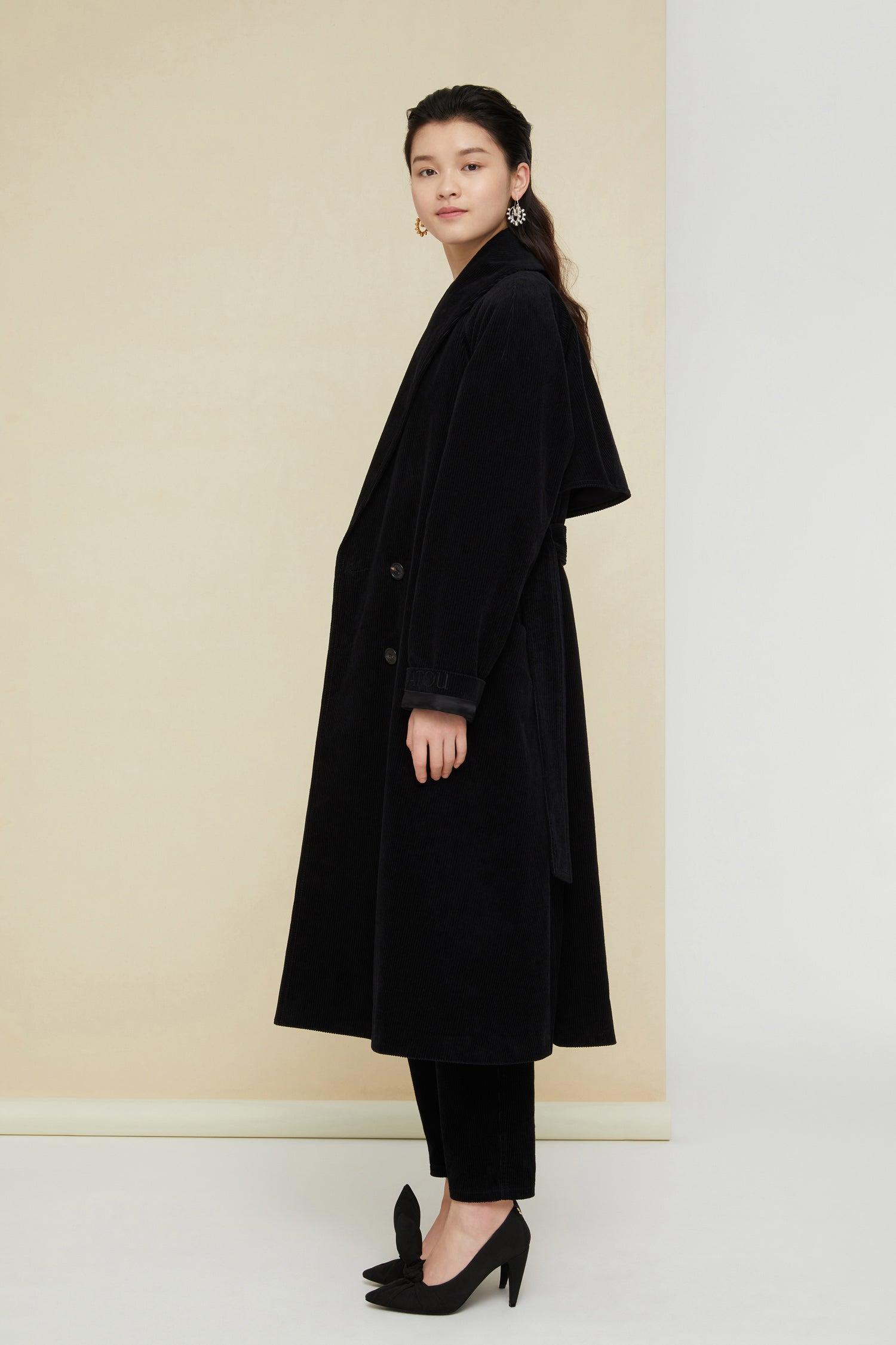 Patou - Corduroy trenchcoat - Black - A tailoring classic with a soft velvet touch.Signature Patou trenchcoat in black corduroy. Double-breasted style with a slight A-line silhouette. Button fastening and belted waist. Two pockets at the sides. Fully lined.