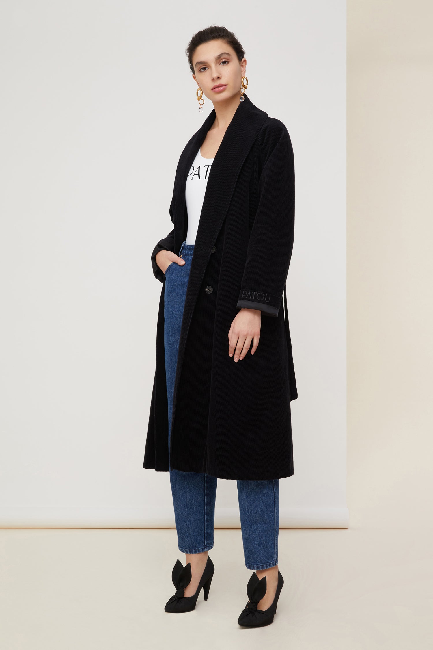 Patou - Corduroy trenchcoat - Black - A tailoring classic with a soft velvet touch.Signature Patou trenchcoat in black corduroy. Double-breasted style with a slight A-line silhouette. Button fastening and belted waist. Two pockets at the sides. Fully lined.