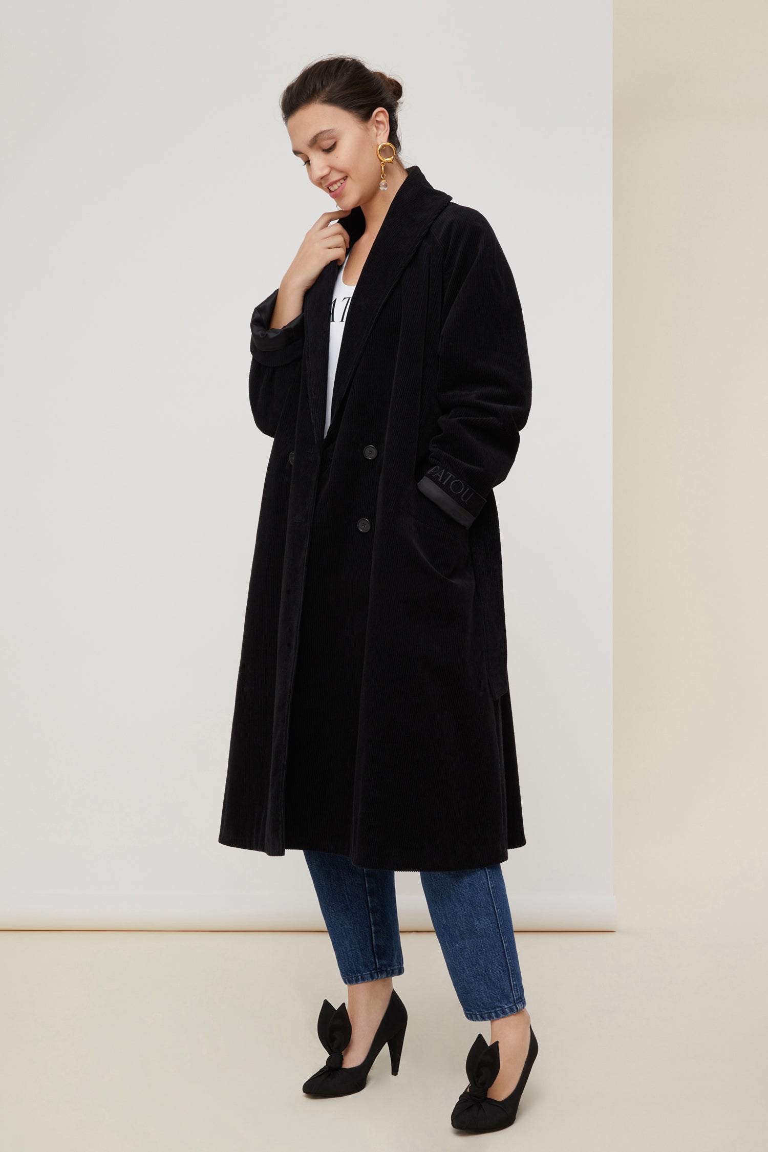 Patou - Corduroy trenchcoat - Black - A tailoring classic with a soft velvet touch.Signature Patou trenchcoat in black corduroy. Double-breasted style with a slight A-line silhouette. Button fastening and belted waist. Two pockets at the sides. Fully lined.