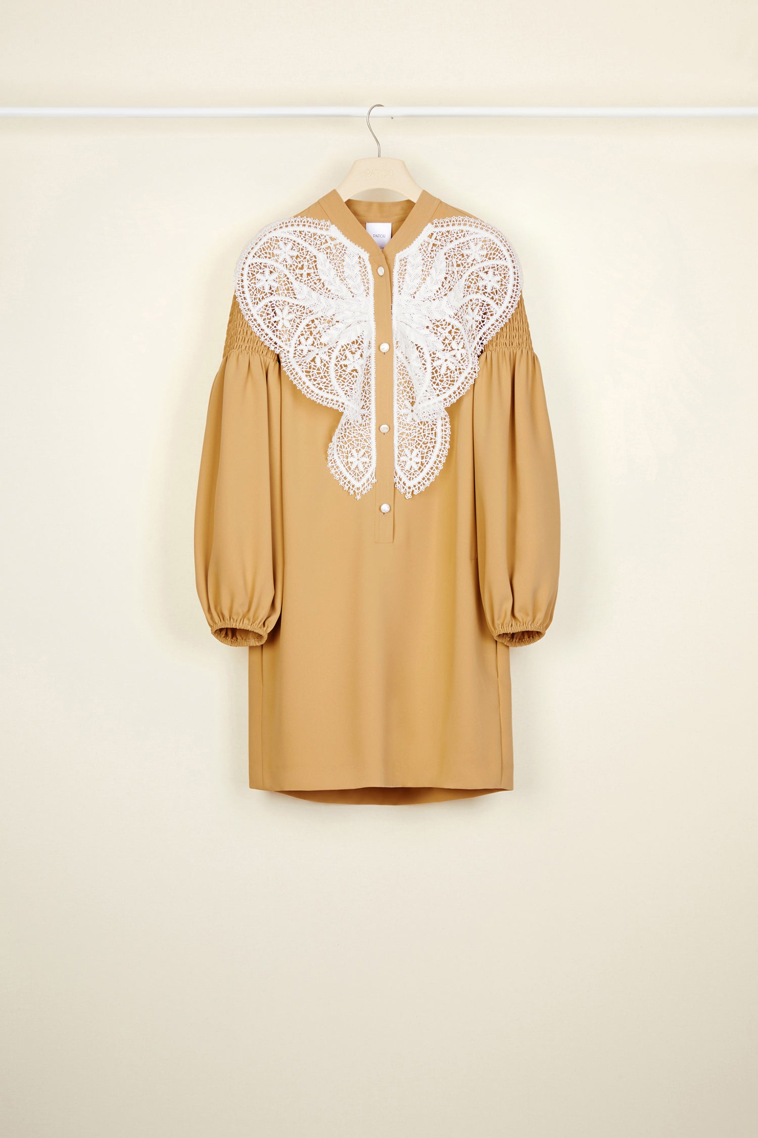 Patou - Lace bib dress - Sand - The day dress is best worn with a touch of lace.Sand-coloured cady dress with white lace bib. Mother-of-pearl buttons down the front. Long sleeves, smocked at the top with elasticated cuffs. Pockets at the sides.