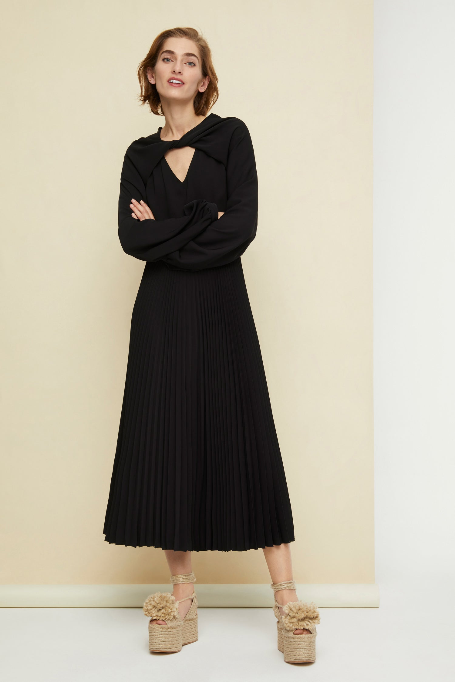 Patou - Twisted neckline pleated midi dress - Black - Twisting and pleating. Black cady midi dress. Long sleeves twisted at the collar over a V neckline. Zip fastening at the back. Ruched detailing at the front. Mother-of-pearl buttons at the cuffs. Pleated skirt.