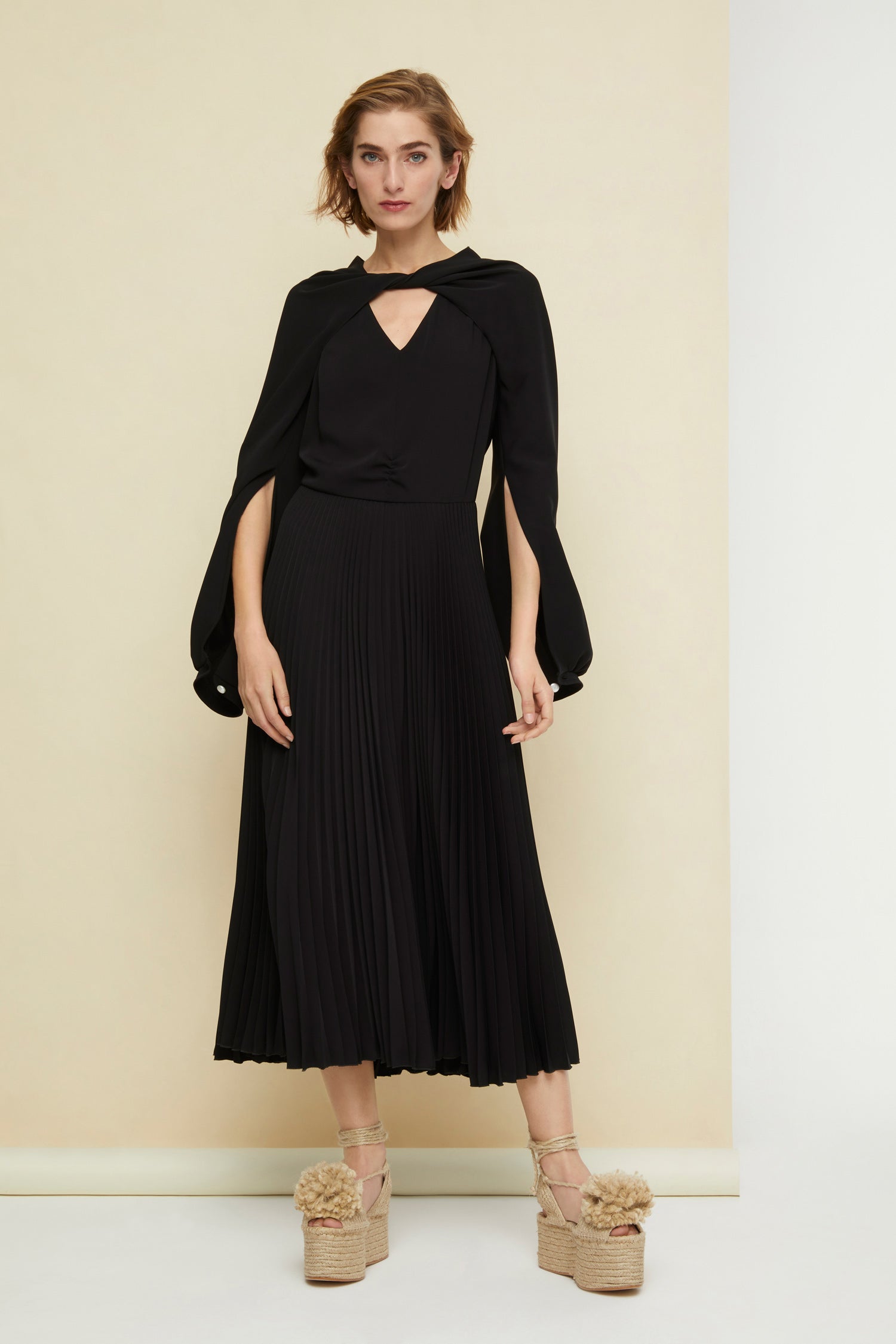 Patou - Twisted neckline pleated midi dress - Black - Twisting and pleating. Black cady midi dress. Long sleeves twisted at the collar over a V neckline. Zip fastening at the back. Ruched detailing at the front. Mother-of-pearl buttons at the cuffs. Pleated skirt.