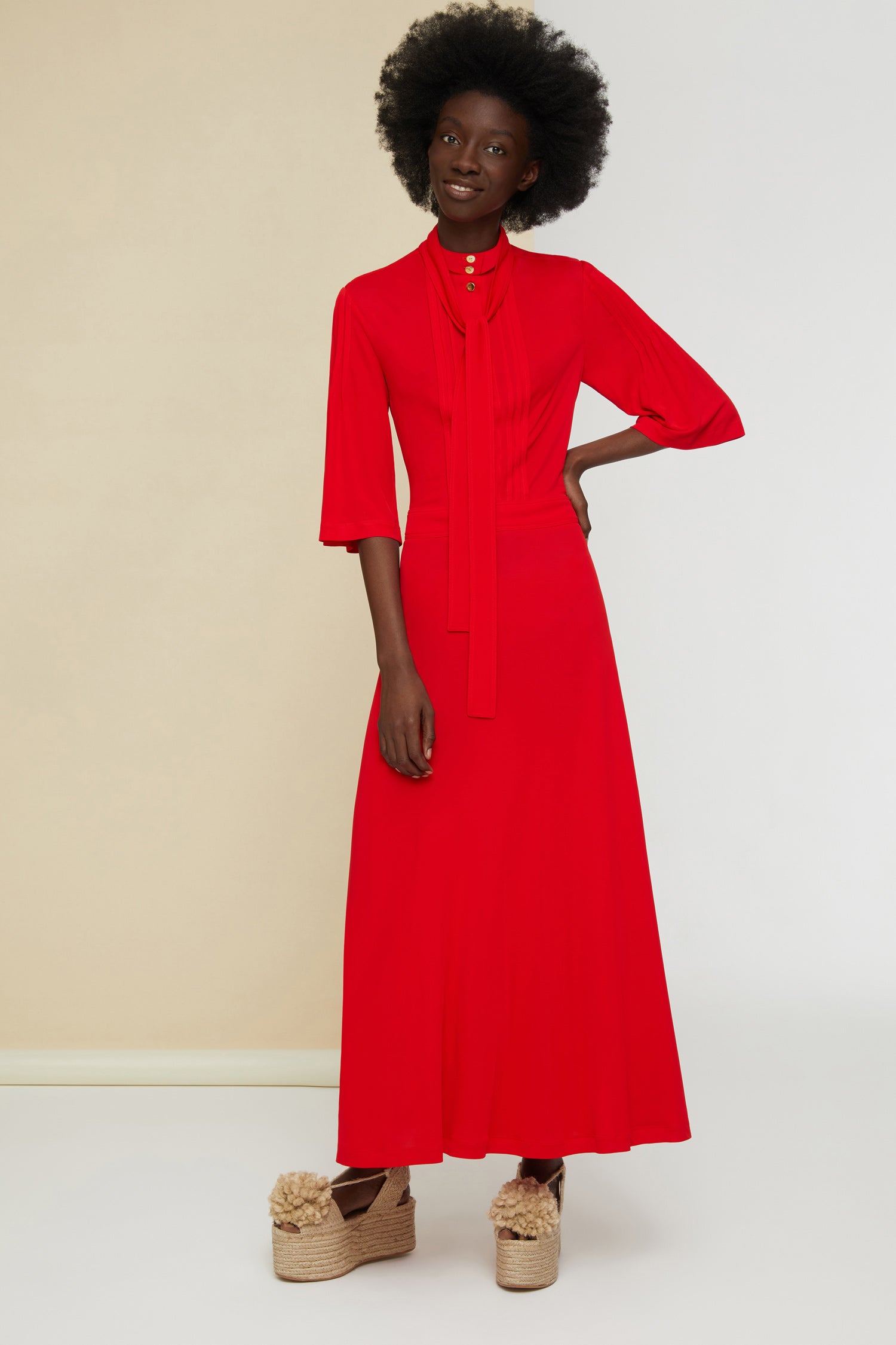 Patou - Necktie midi dress - Poppy - Pleats and ties and gold accents.Poppy red jersey dress. High collar with long ties around the neck. Micropleating down the bodice. Gold-coloured buttons at the front. Cropped sleeves. Midi skirt with pockets and buttons at the sides. Side pockets. Concealed side zip.