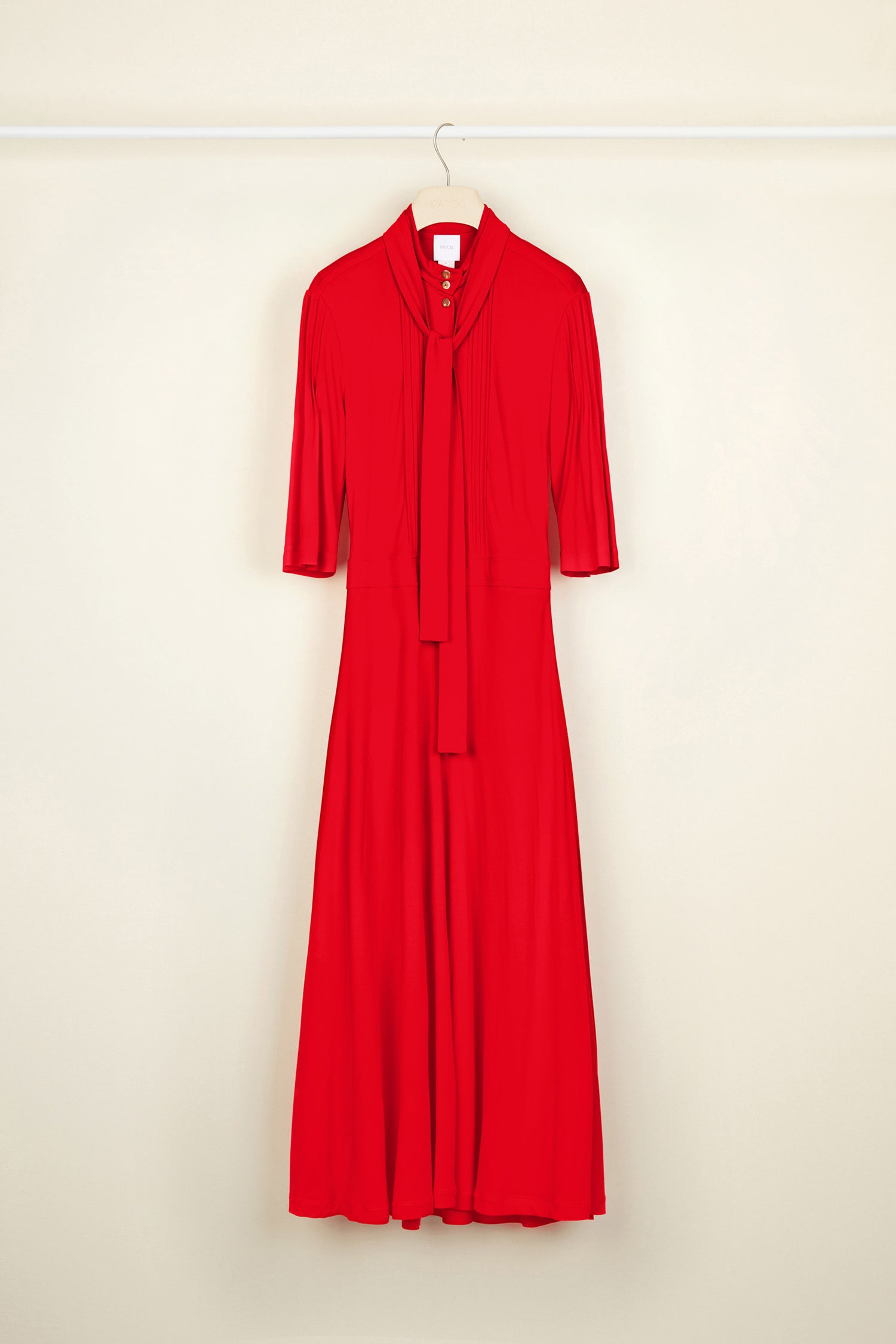 Patou - Necktie midi dress - Poppy - Pleats and ties and gold accents.Poppy red jersey dress. High collar with long ties around the neck. Micropleating down the bodice. Gold-coloured buttons at the front. Cropped sleeves. Midi skirt with pockets and buttons at the sides. Side pockets. Concealed side zip.