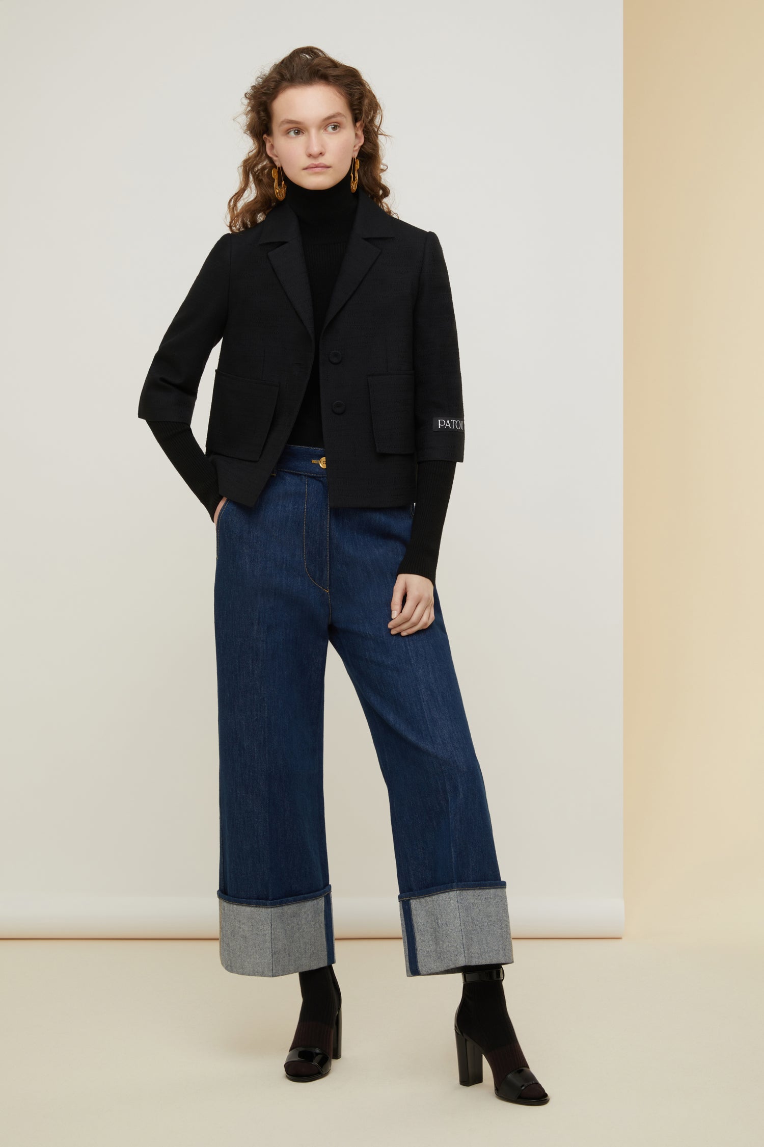 Patou - Box jacket in organic tweed - Black - Cropped and tweaked, classic tailoring with a Patou point of view. Black cotton and wool tweed jacket. Box silhouette with single vent at the back. Single-breasted style with two fabric-covered buttons at the front. Black Patou label on the left sleeve. Mock flap pockets at the front. Fully lined.