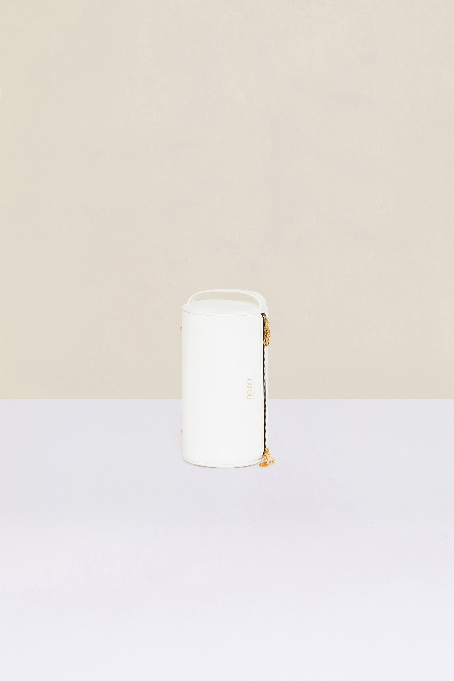 Patou - Barrel bag in faux leather - White - Meet the Patou bag: functional and whimsical, a new design for the everyday.White faux leather handbag. Barrel shape inspired by a pétanque bag. Adjustable strap that can be worn short or long. Gold-coloured hardware. Multiple zip tabs with JP logo inspired by a heritage keyring. Patou lettering logo. Small pocket inside.