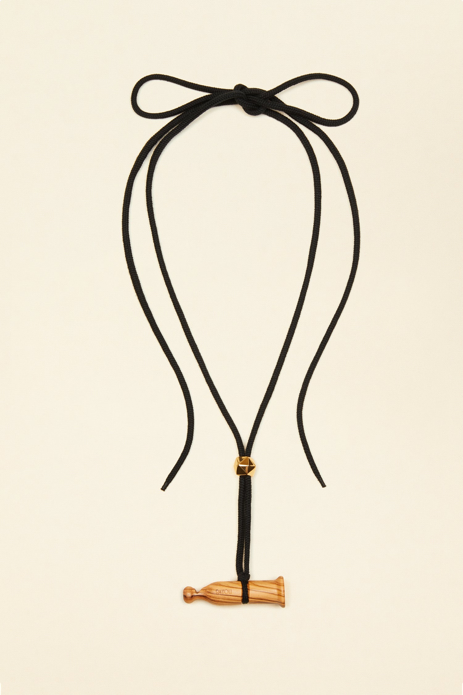 Patou - Appeau necklace - Chestnut - A wooden whistle charm makes for a charming finishing touch.Black cord necklace with attached wooden pendant modelled after a traditional bird call. Gold-tone bead. Engraved Patou logo.