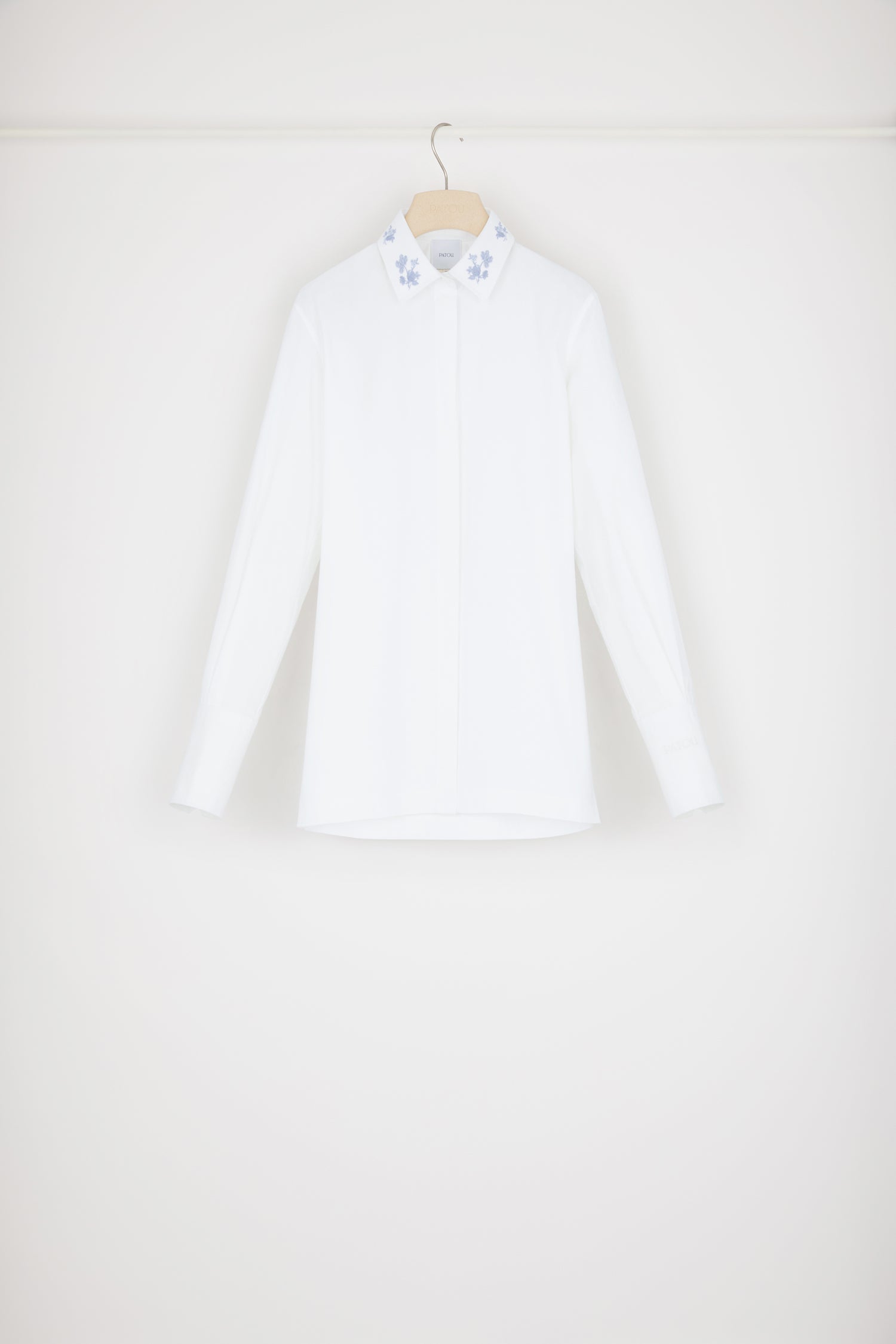 Patou - Signature organic cotton shirt with embroidered collar - White - Embroidery is Patou&amp;#39;s love language. White cotton shirt. Signature longline silhouette. Embroidered collar with floral motifs. Concealed button fastening at the front. Buttoned cuffs. Patou logo embroidered on the left cuff. Split sides.