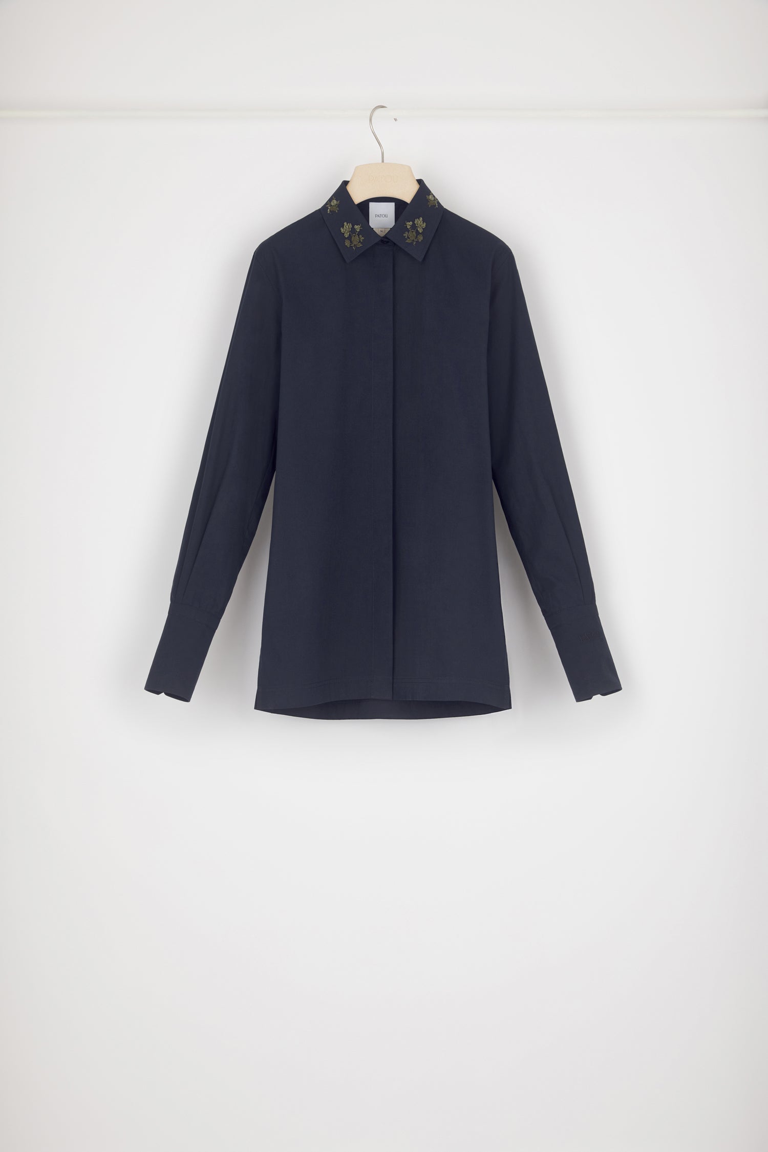 Patou - Signature organic cotton shirt with embroidered collar - Parisian Night - Embroidery is Patou&amp;#39;s love language. Parisian Night navy cotton shirt. Signature longline silhouette. Embroidered collar with floral motifs. Concealed button fastening at the front. Buttoned cuffs. Patou logo embroidered on the left cuff. Split sides.