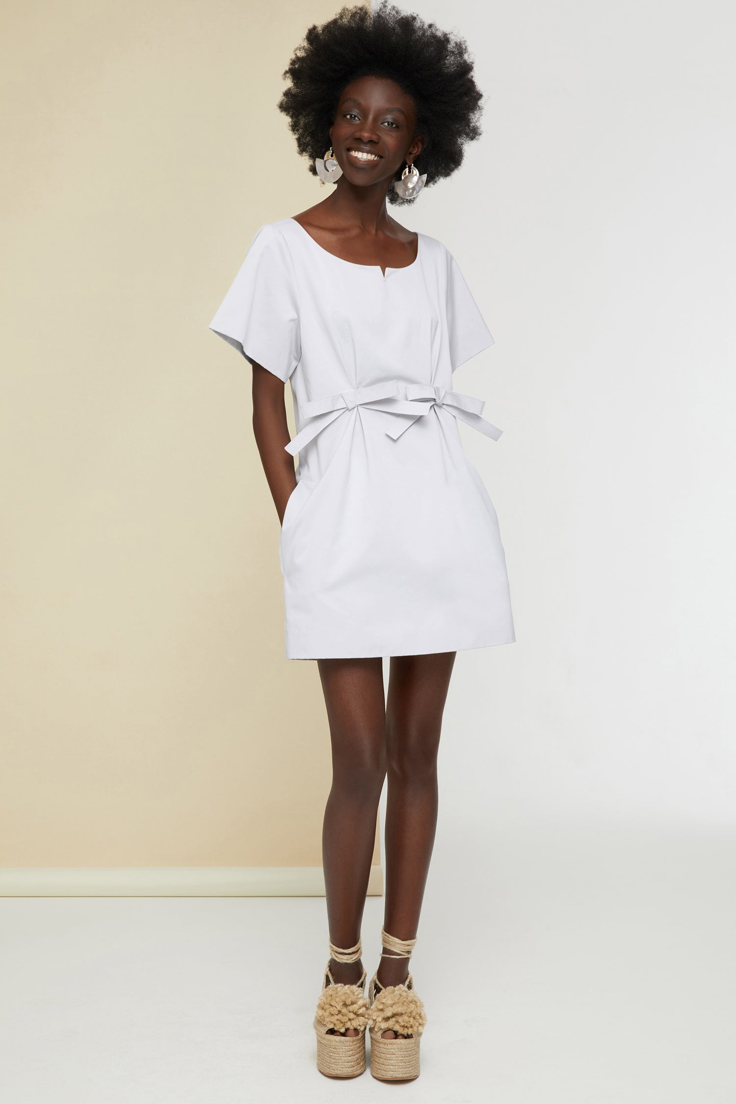 Patou - Bow cotton mini dress - Light Grey - The understated bow.Light grey eco-conscious cotton satin mini dress. Round neckline with small cut-out. Short sleeves. Two flat bows at the front. Zip fastening at the back. Pockets at the sides.