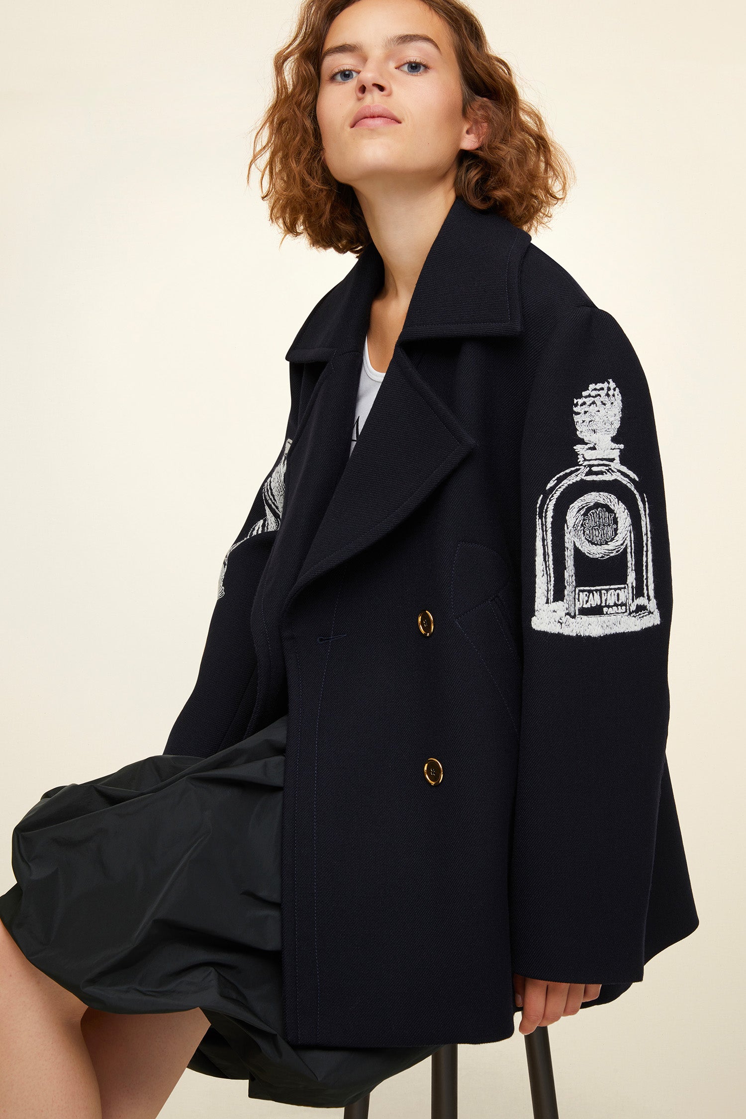 Patou - Oversized embroidered virgin wool peacoat - Navy - A day coat with a touch of fantasy!  Navy virgin wool peacoat. Double-breasted style with exaggerated lapels. Embroidered with white Patou heritage motifs (perfume bottle, Greek column). Gold-coloured buttons and gold embroidered logo on the sleeve. Slit pockets at the sides. Fully lined.