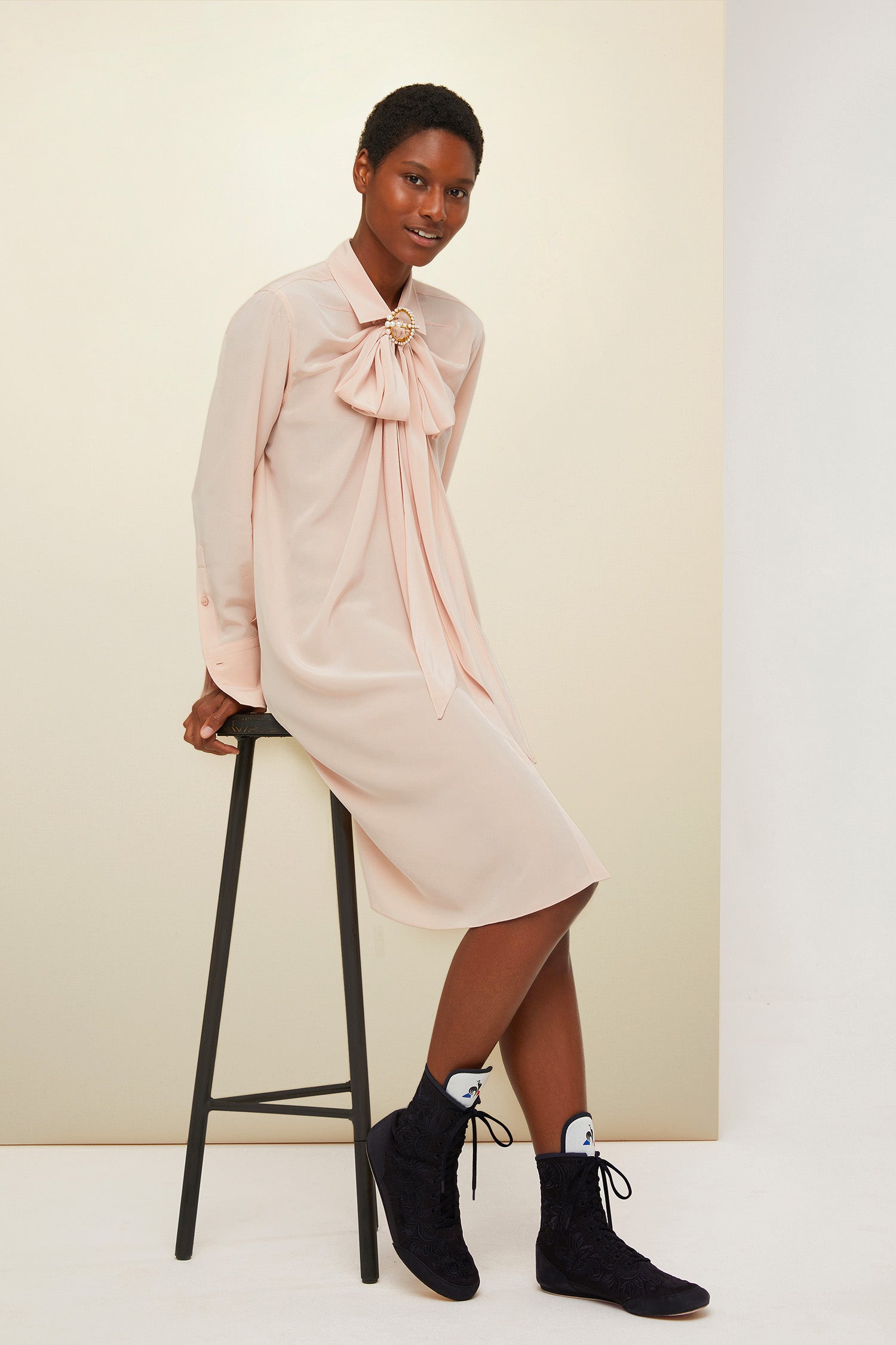 Patou - Pussy-bow mini silk shirtdress - Golden Beige - The understated appeal of the undone pussy bow.  Golden beige silk crepe mini shirtdress. Classic shirt collar with loose pussy-bow ties and shirred detailing around the neckline. Concealed engraved mother-of-pearl buttons down the front; buttoned cuffs. Pearl brooch sold separately.