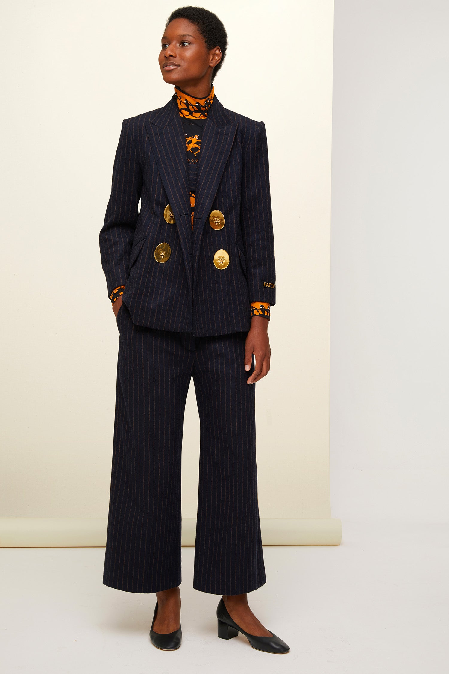Patou - Double-breasted chalk stripe wool jacket - Navy Sienna - The allure of stripes.  Double-breasted navy and burnt sienna chalk stripe wool jacket. Buttons at the front and on the cuffs. Tailor-style Patou label on the sleeve. Two flap pockets at the front, one internal pocket. Single high vent at the back with button fastening. Fully lined. Brooches sold separately.