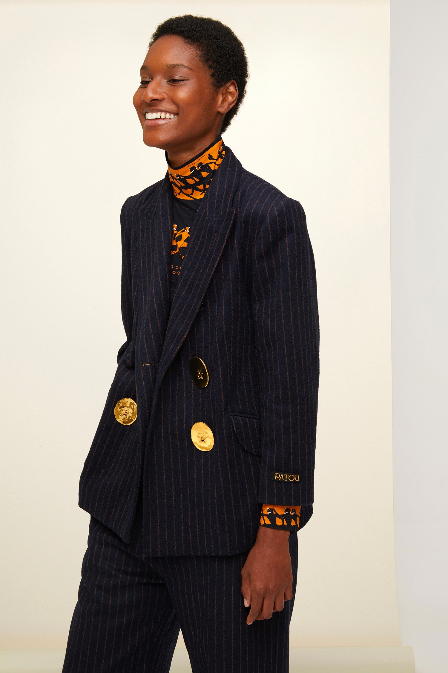 Patou - Double-breasted chalk stripe wool jacket - Navy Sienna - The allure of stripes.  Double-breasted navy and burnt sienna chalk stripe wool jacket. Buttons at the front and on the cuffs. Tailor-style Patou label on the sleeve. Two flap pockets at the front, one internal pocket. Single high vent at the back with button fastening. Fully lined. Brooches sold separately.