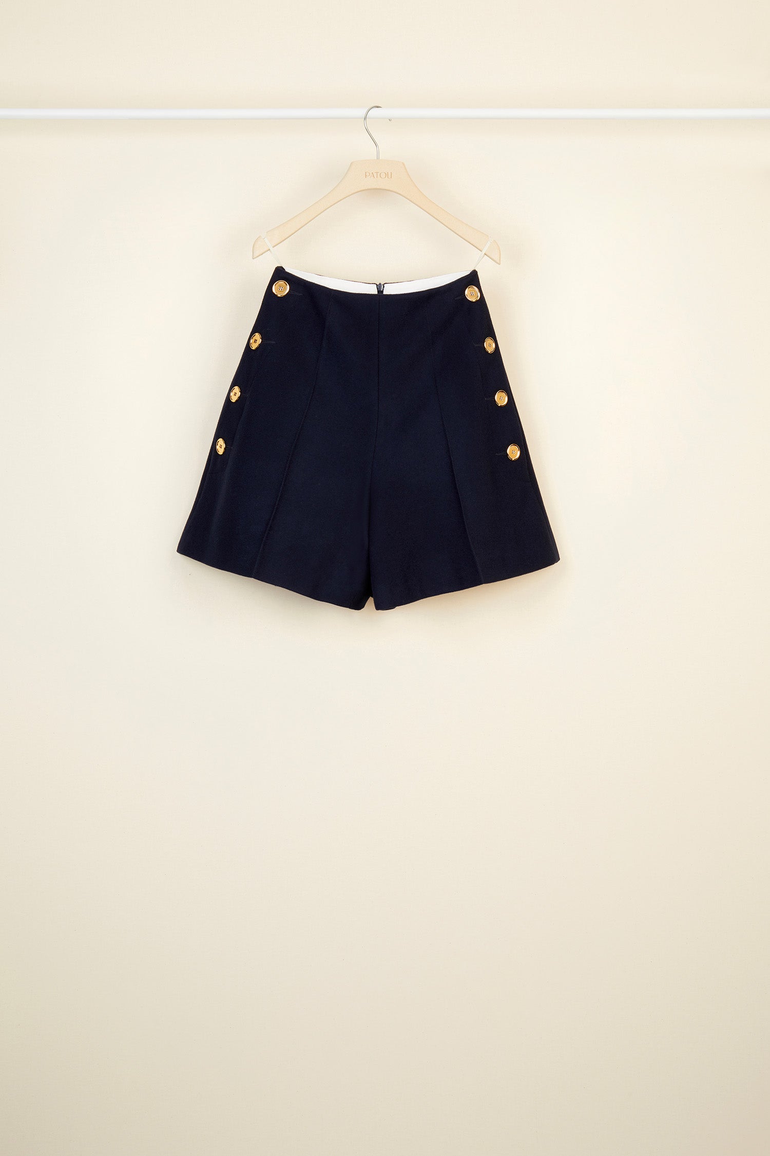 Patou - Iconic cashmere and wool shorts - Navy - High-shine buttons brighten up dark wool.Patou’s iconic tailored shorts in navy cashmere and wool flannel. High-waisted style with two rows of engraved gold-coloured buttons at the sides. Large side pockets. Concealed zip fastening at the back. Lined.