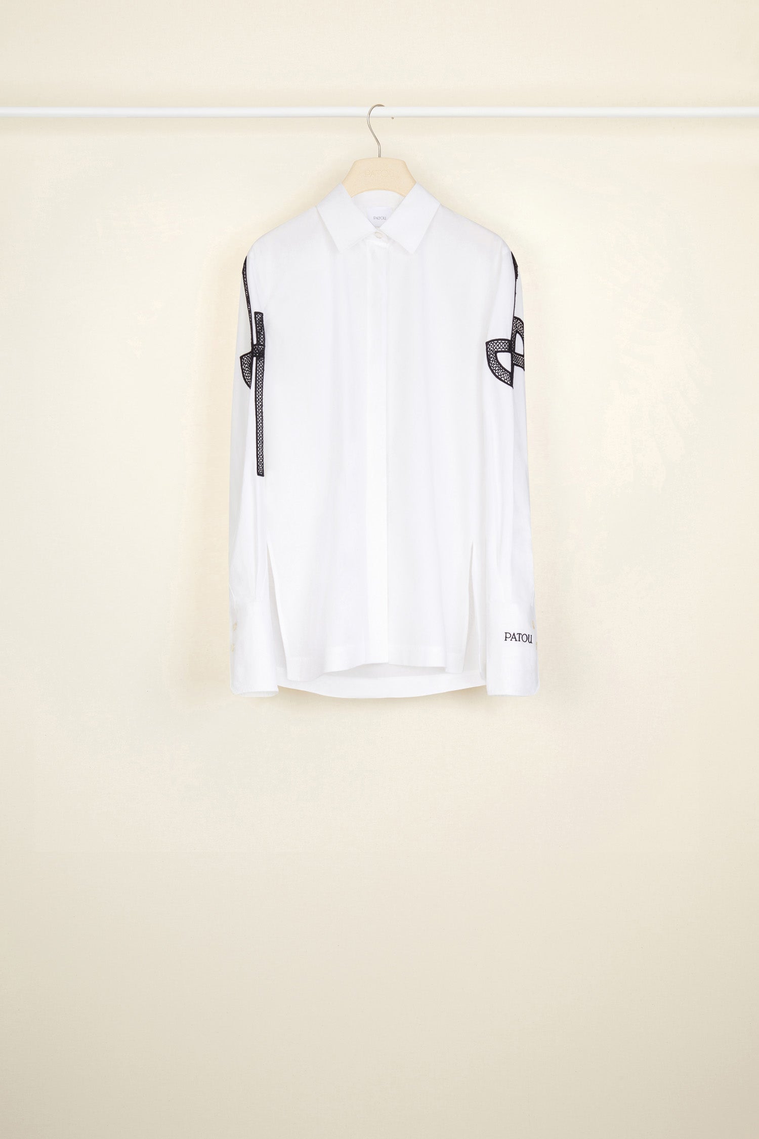 Patou - Embroidered logo shirt in organic cotton - White - JPs and embroideries: modern Patou signatures.White organic cotton shirt with contrasting embroideries. Spread collar. Concealed button fastening; buttoned cuffs. Side vents. Stylised JP logo embroidered in black on both sleeves; black Patou logo on the left cuff.