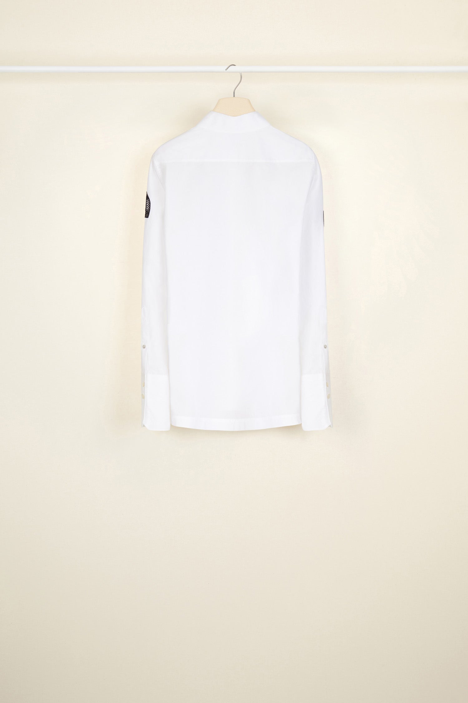 Patou - Embroidered logo shirt in organic cotton - White - JPs and embroideries: modern Patou signatures.White organic cotton shirt with contrasting embroideries. Spread collar. Concealed button fastening; buttoned cuffs. Side vents. Stylised JP logo embroidered in black on both sleeves; black Patou logo on the left cuff.
