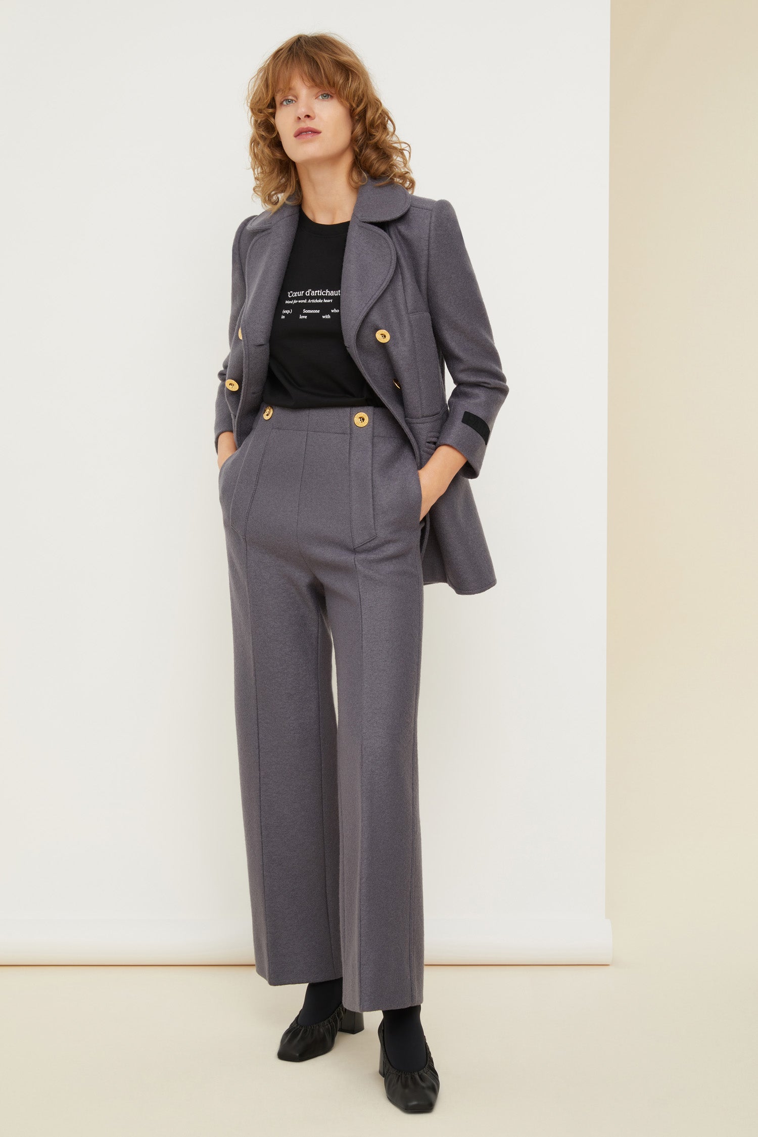 Patou - Longline double-breasted wool jacket - Storm - Seams and darts, the quiet couture details that scream Patou!  Grey boiled wool double-breasted jacket. Longline fitted silhouette with signature curved seams, darts at the waist and two vents at the back. Double rounded lapels. Gold-coloured buttons engraved with the Patou logo. Slightly cropped sleeves. Patou label on the left sleeve. Two mock pockets at the sides, two oversized patch pockets at the front.