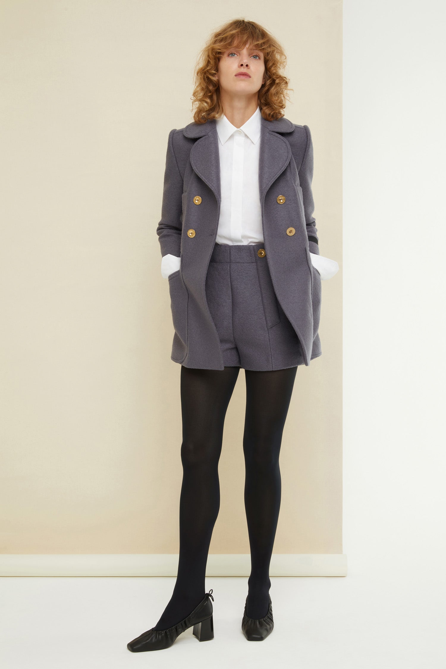 Patou - Longline double-breasted wool jacket - Storm - Seams and darts, the quiet couture details that scream Patou!  Grey boiled wool double-breasted jacket. Longline fitted silhouette with signature curved seams, darts at the waist and two vents at the back. Double rounded lapels. Gold-coloured buttons engraved with the Patou logo. Slightly cropped sleeves. Patou label on the left sleeve. Two mock pockets at the sides, two oversized patch pockets at the front.