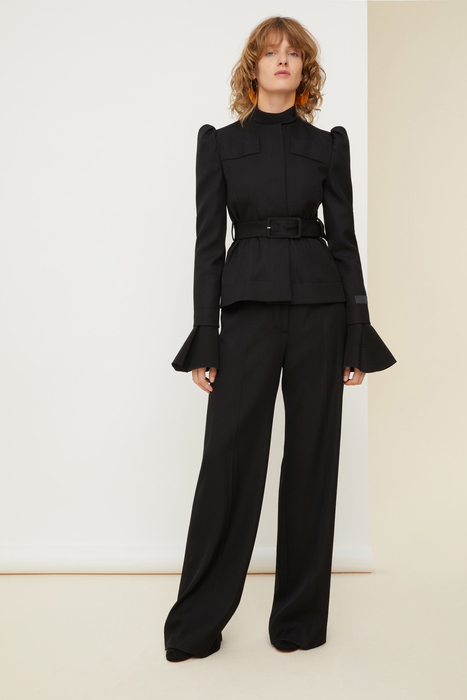 Patou - Cropped tricotine wool jacket - Black - La fille Patou likes it cropped! Black tricotine wool jacket. Cropped silhouette that can be worn with or without the belt. Slight puff sleeves with gathered shoulders. Mock scallop pockets across the chest. Concealed button fastening. Patou label on the left sleeve. Brooches sold separately