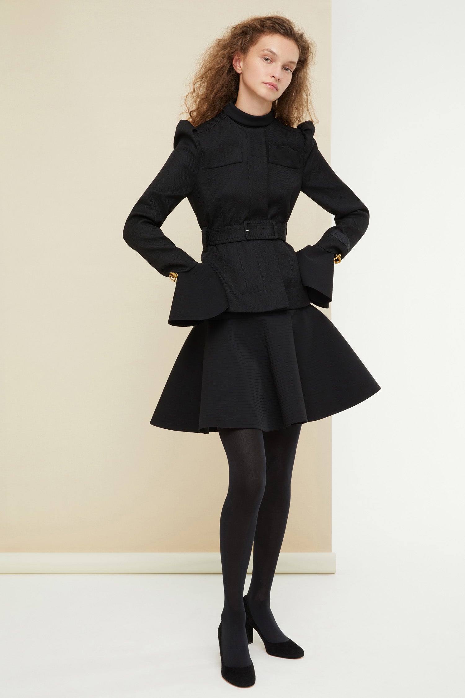 Patou - Cropped tricotine wool jacket - Black - La fille Patou likes it cropped! Black tricotine wool jacket. Cropped silhouette that can be worn with or without the belt. Slight puff sleeves with gathered shoulders. Mock scallop pockets across the chest. Concealed button fastening. Patou label on the left sleeve. Brooches sold separately