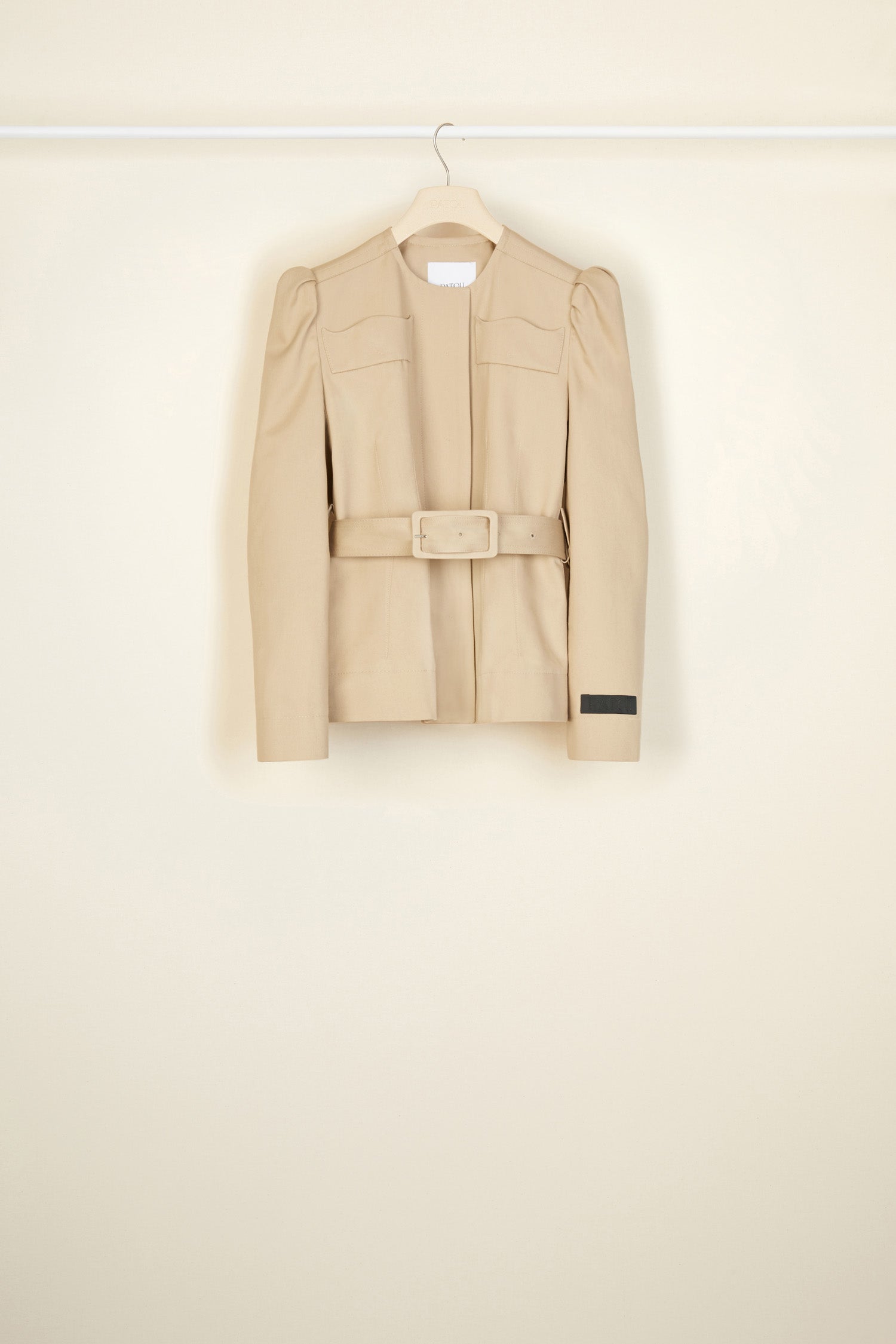 Patou - Cropped gabardine jacket in organic cotton - Sand - La fille Patou likes it cropped!Sand beige cotton gabardine jacket. Cropped silhouette that can be worn with or without the belt. Slight puff sleeves with gathered shoulders. Mock scallop pockets across the chest. Concealed button fastening. Embroidered black Patou label on the left sleeve. Fully lined.