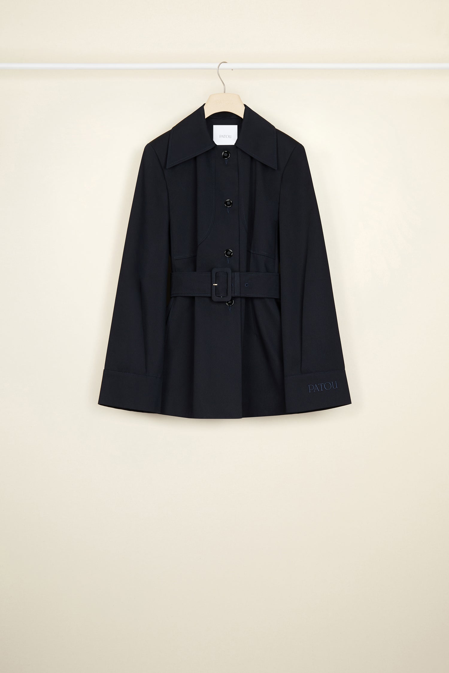 Patou - Belted jacket in organic cotton - Night Blue - Belted and flared: tailoring with the Patou touch.Night blue organic cotton jacket. Slightly flared silhouette. Spread collar. Button fastening down the front. Long sleeves with wide cuffs. Patou lettering logo embroidered on the left cuff. Wide fabric belt with adjustable buckle. Pockets at the sides. Fully lined.