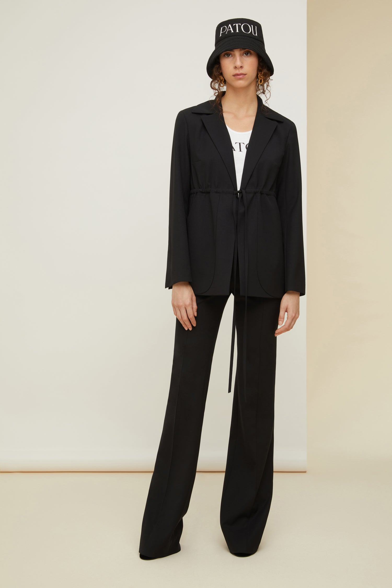 Patou - Drawstring wool jacket - Black - Subtly cinched, unmistakably Patou.Black stretch virgin wool jacket. Notch lapels. Adjustable drawstring at the waist that fastens at the front. Large pockets with curved seams. Split cuffs. Single vent at the back.