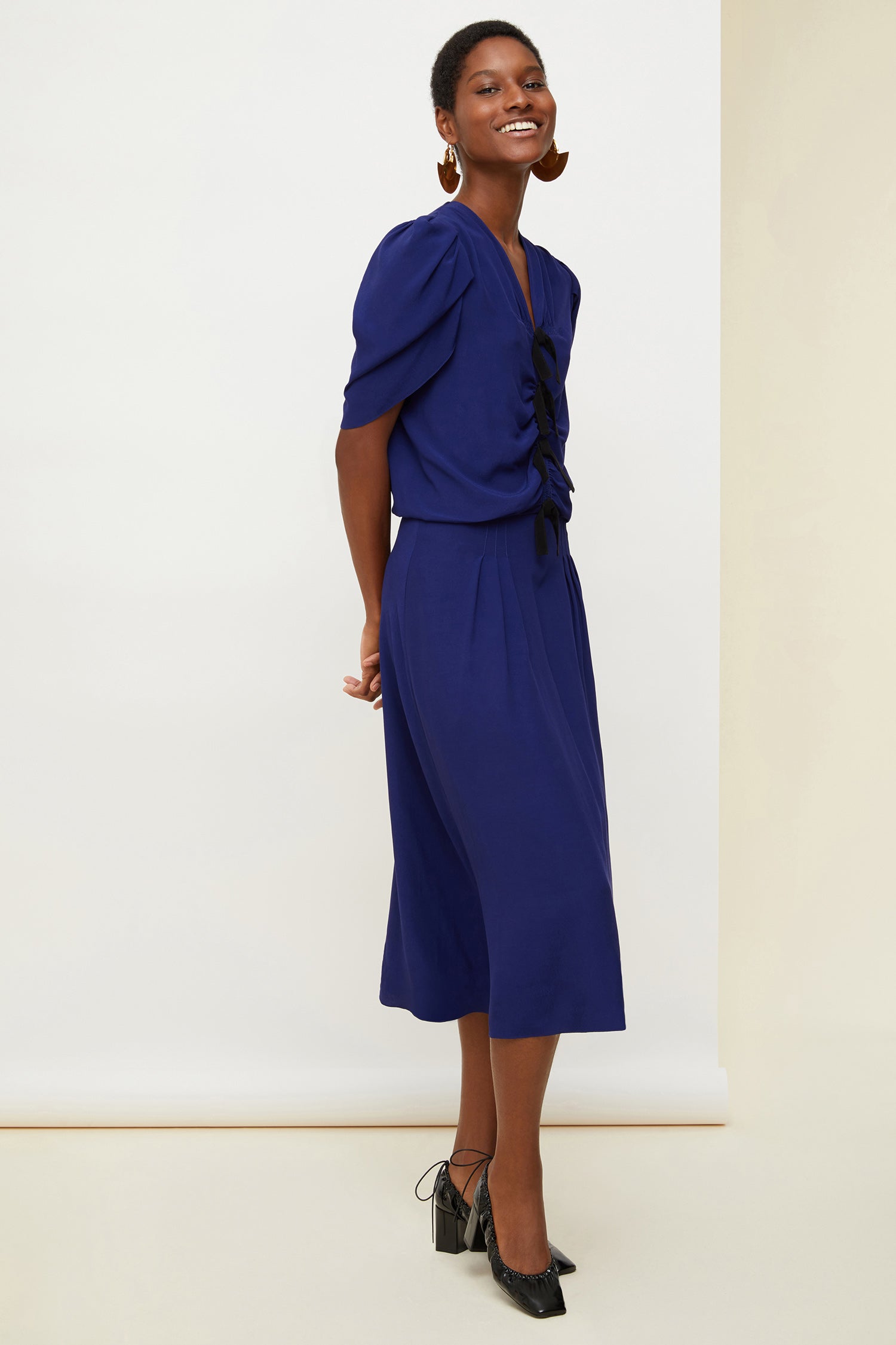 Patou - Bow-embellished ruched dress - Persian Blue - Bows and ruches.Persian Blue ruched viscose dress. Multiple black bows at the front. Short tulip sleeves. Zip fastening at the back. Long skirt with pleats at the front and box pleat at the back.
