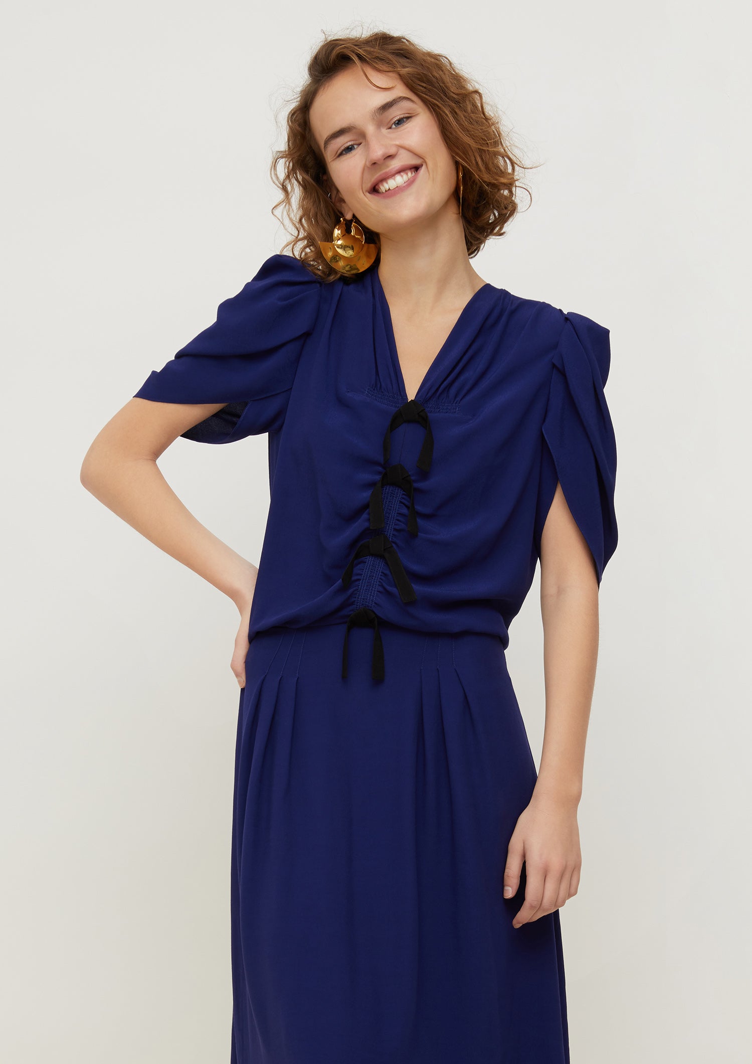 Patou - Bow-embellished ruched dress - Persian Blue - Bows and ruches.Persian Blue ruched viscose dress. Multiple black bows at the front. Short tulip sleeves. Zip fastening at the back. Long skirt with pleats at the front and box pleat at the back.