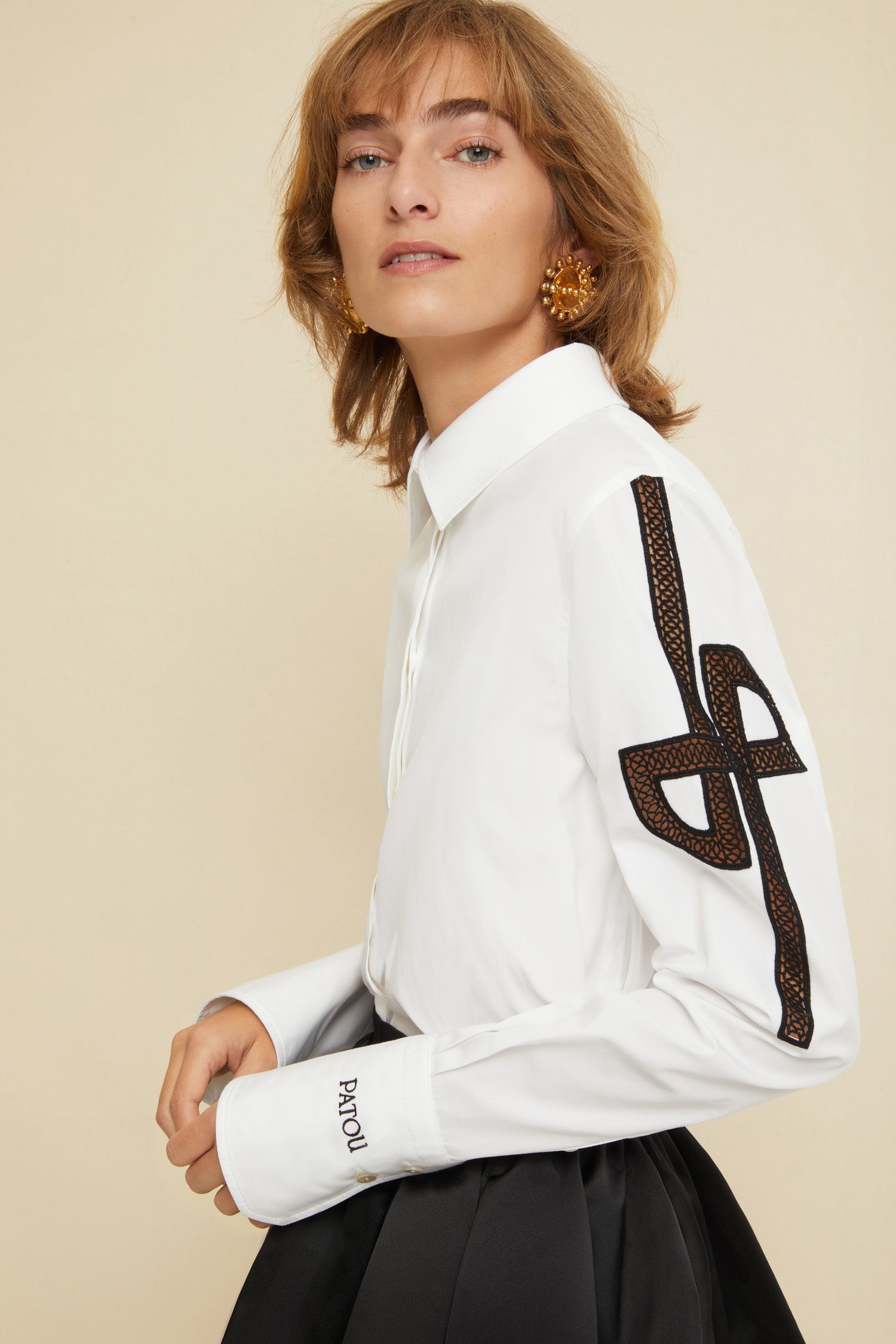Patou - Embroidered logo shirt in organic cotton - White - JPs and embroideries: modern Patou signatures.White organic cotton shirt with contrasting embroideries. Spread collar. Concealed button fastening; buttoned cuffs. Side vents. Stylised JP logo embroidered in black on both sleeves; black Patou logo on the left cuff.