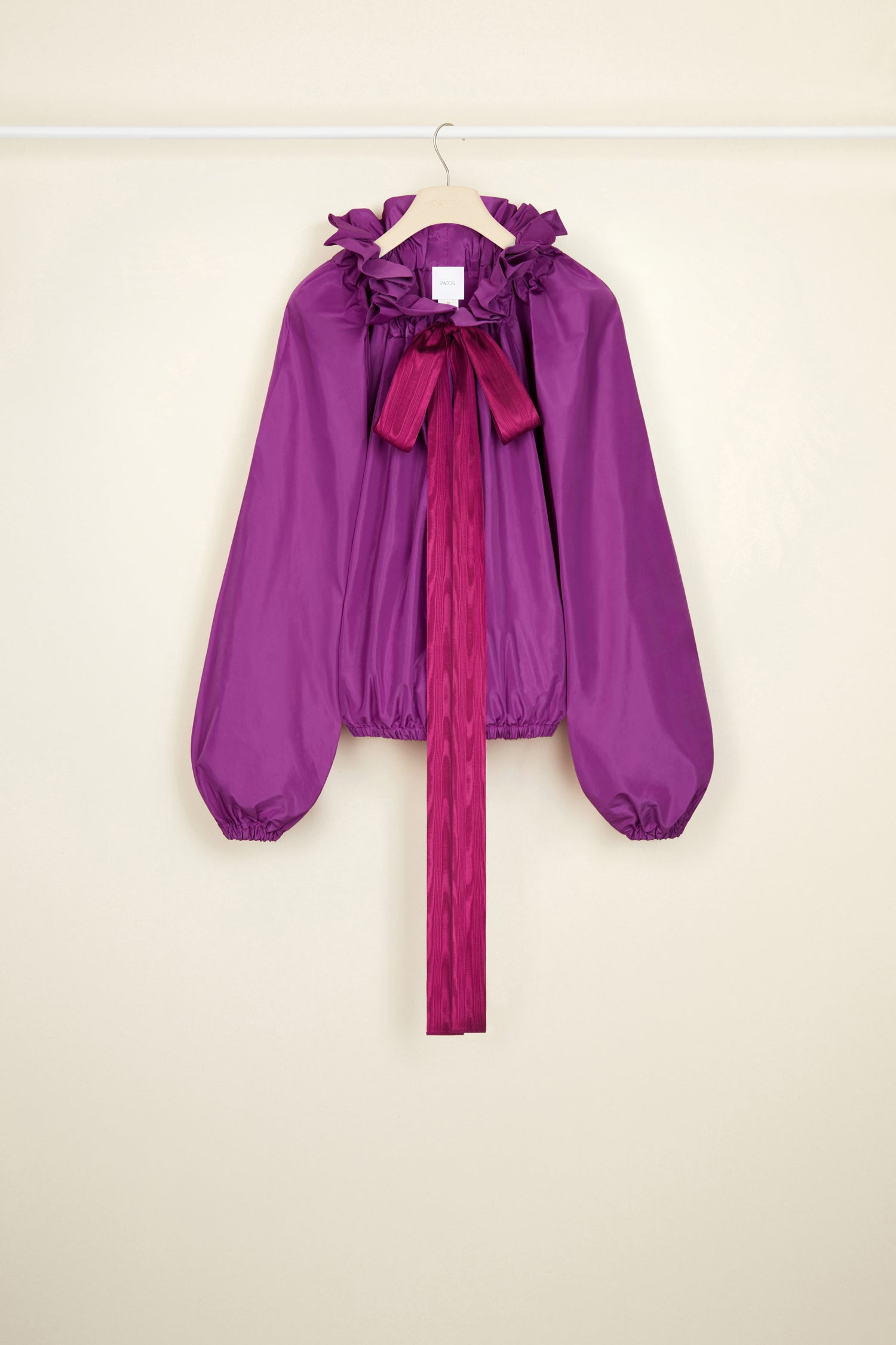 Patou - Drawstring collar top in eco-friendly faille - Anemone - High collar or bare embossed shoulder? With Patou, it’s all about you.Anemone purple recycled polyester faille top. High volume silhouette that can be worn knotted at the neck or off the embossed shoulders. Drawstring collar with flounce at the front and long grosgrain ties. Batwing sleeves with elasticated cuffs. Elasticated waist.