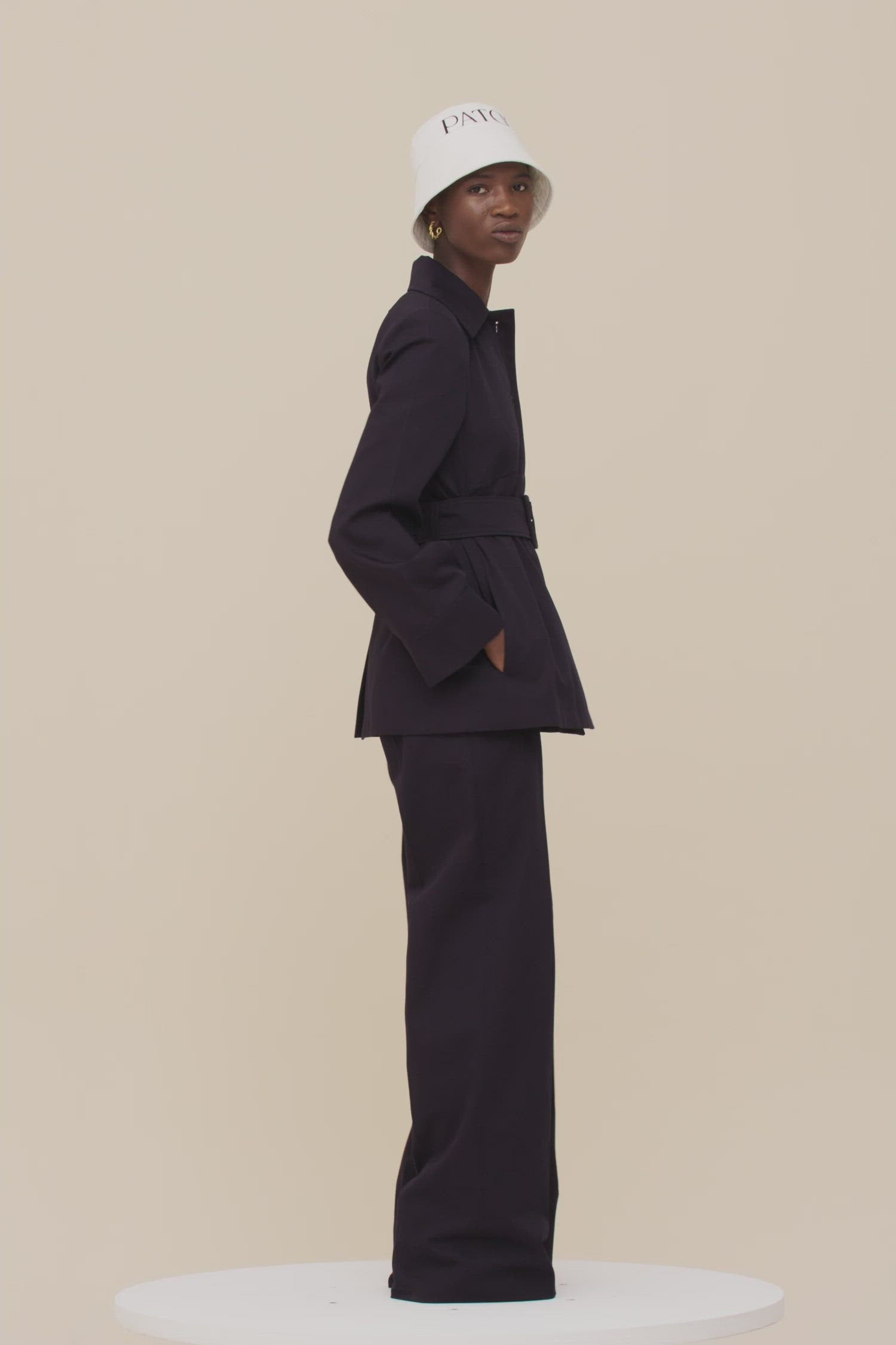 Patou - Belted jacket in organic cotton - Night Blue - Belted and flared: tailoring with the Patou touch.Night blue organic cotton jacket. Slightly flared silhouette. Spread collar. Button fastening down the front. Long sleeves with wide cuffs. Patou lettering logo embroidered on the left cuff. Wide fabric belt with adjustable buckle. Pockets at the sides. Fully lined.